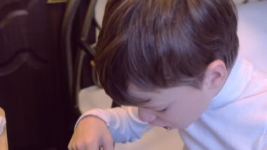 Oğlan hostel yatakta oturup anlık erişte yiyor.