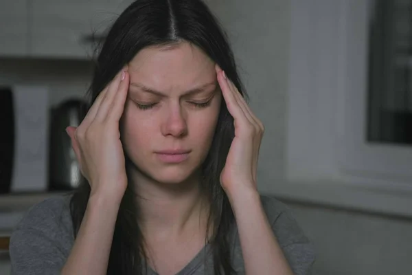 Woman with headache in the kitchen at night. Insomnia and depression. — Stock Photo, Image