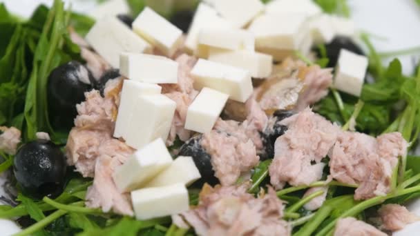 Ensalada de verduras, queso, aceitunas y pescado de cerca en un plato. Alimento saludable . — Vídeos de Stock