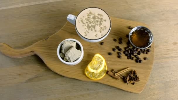 Kopp kaffe med halva serveras på en bricka med honung och kaffe bönor. — Stockvideo