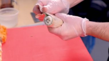 Şef aşçılar bambu hasır ile alır. Eller yakın çekim.