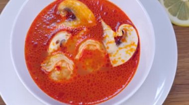 Karides çorbası ile mantar, yeşil ve limon, Tom Yam Kung, Tayland yemeği. Cook yeşillik çorba koyar..