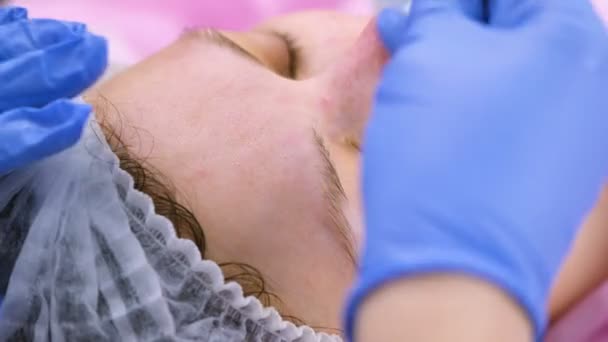 Косметолог миє жіноче обличчя з маски за допомогою бавовняних накладок. Крупним планом обличчя . — стокове відео