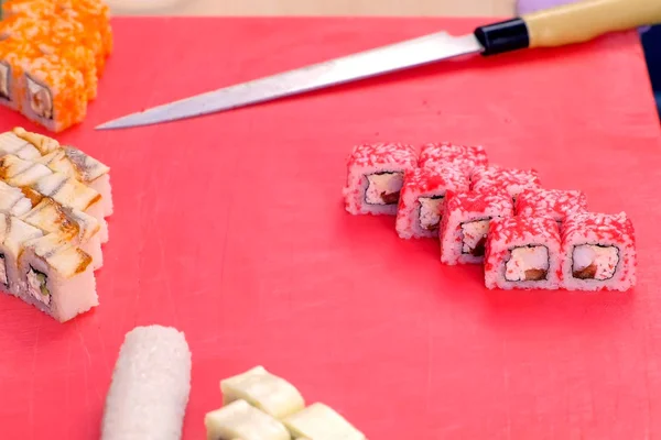 Cocina rollos con caviar rojo en la parte superior. Corta rollos . —  Fotos de Stock