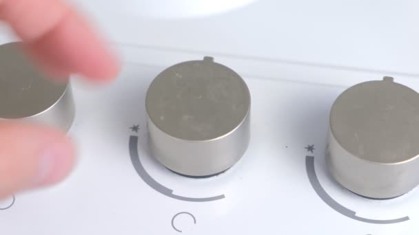 Man presses the rotary switch to turn on gas stove. — Stock Video