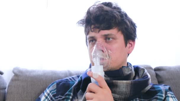 Use nebulizador e inhalador para el tratamiento. Hombre enfermo inhalando a través de la máscara del inhalador . — Vídeo de stock