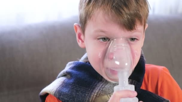 Nemocný blonďák vdechují přes inhalátor masku. Použijte rozprašovač a inhalátor pro léčbu. — Stock video