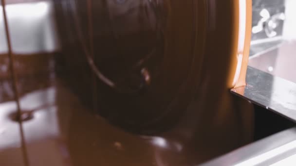 Warm liquid chocolate in Chocolate tempering machine. Close-up view. Production of chocolate candys. — Stock Video