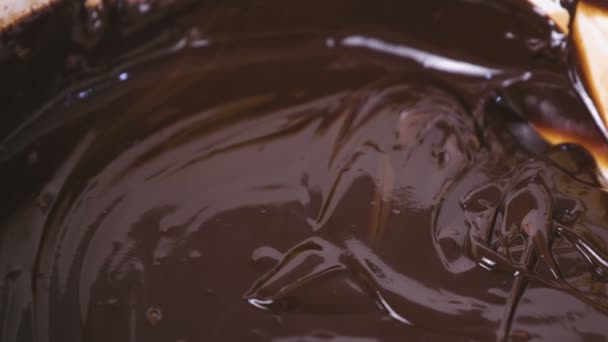 Dark chocolate in a white bowl. Close-up view. — Stock Video