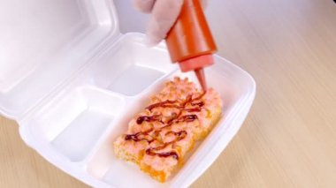 Cook wasabi ve zencefil'dır restoranda plastik kutusu rulo koyar. Eller yakın çekim.
