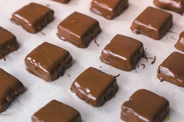 Handmade chocolate candies on baker sheet. Production of chocolate candies.