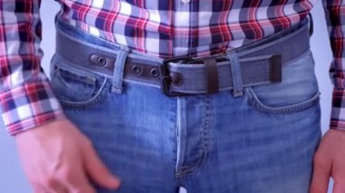 Man is touching his dick in jeans and slapping by hand.
