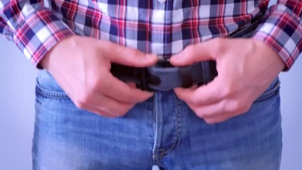 Man is touching a belt on his jeans, hands closeup. — Stock Video