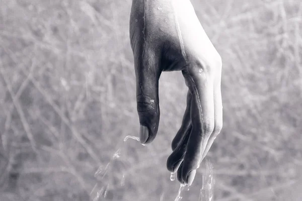 stock image Water is flowing through the womans hand. Hand close-up.