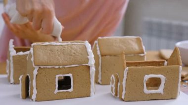 Womans eller zencefilli evler şeker tatlı krema ile ayrıntıları tutkallar olun. Pişirme ev yapımı zencefilli ev.