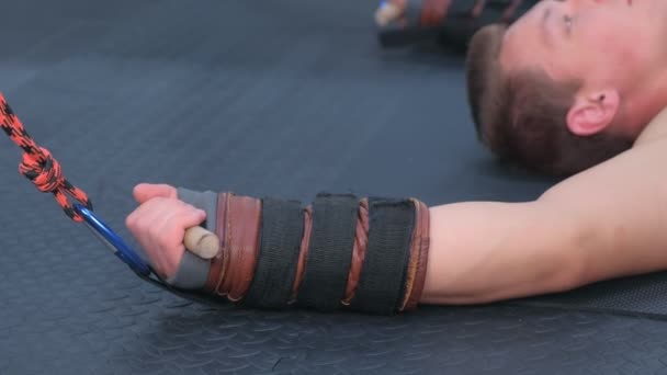 Sportsman using trainer for myofascial stretching in gym, hand closeup. — Stock Video