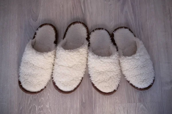 Two pairs of white slippers from sheep wool, closeup view. — Stock Photo, Image