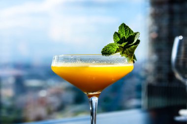 Sarı mango nane yaprağı bir cam ile kokteyl.