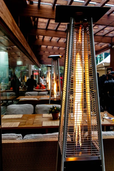 Gas heaters on the veranda of the restaurant, autumn, rain.