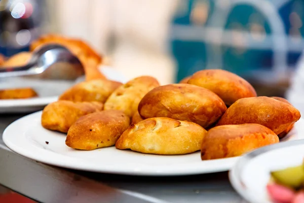 Traditional Russian pies lie on a plate.