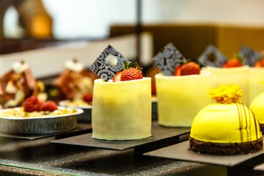 Birçok farklı küçük kek şeker dükkanı camda vardır.