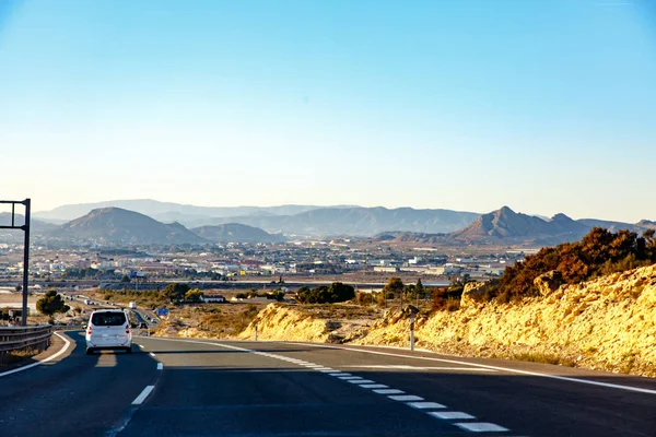 Highway between mountains in the evening