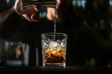 Siyah Rus kokteyli. Barmen bir bardak içinde hazırlar 