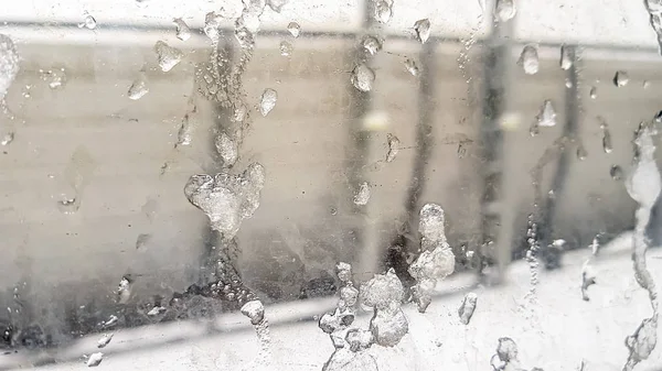 Frozen water droplets on the window glass. Winter — Stock Photo, Image