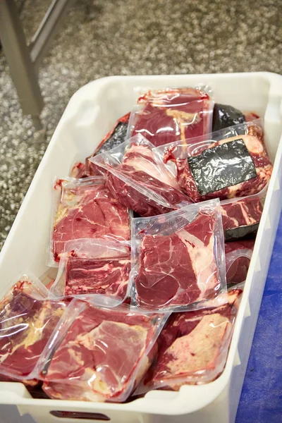 Meat processing plant. Slices of cut beef on the conveyor.