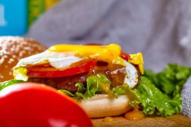 Pirzola, domates ve yumurta ahşap bir tahtanın üzerinde.