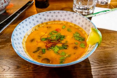 Geleneksel Asya çorbası Tom Yam masada bir tabakta