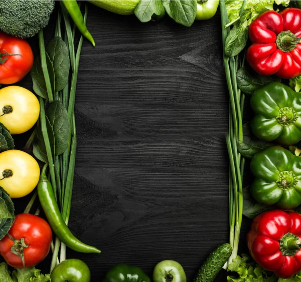 Variety of vegetables arranged in the frame shape, with space for text or advertising. Top view