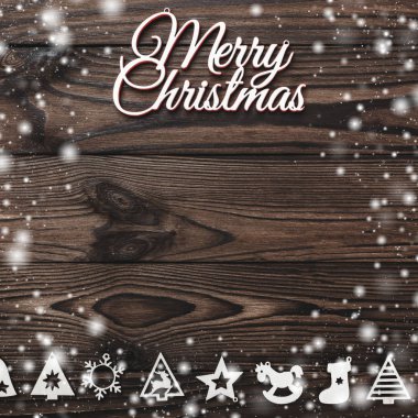 Yukarıdan bir Merry Christmas yazıt ve el yapımı Ağaç oyuncaklar ahşap arka plan, metin yazma, kar efekti için yer ile tebrik kartı üzerinde göster