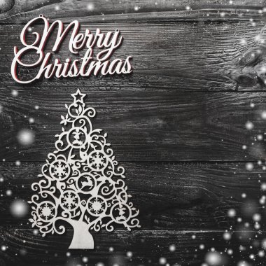 El yapımı yaprak dökmeyen ağaç oyuncak, altın çam ağaçları ve siyah ahşap arka plan, metin yazma, tebrik kartı, için yer ile kitabe Merry Christmas görünümünü yukarıda etkisi kar