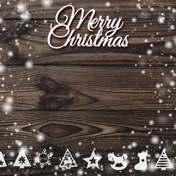 Yukarıdan bir Merry Christmas yazıt ve el yapımı Ağaç oyuncaklar ahşap arka plan, metin yazma, kar efekti için yer ile tebrik kartı üzerinde göster