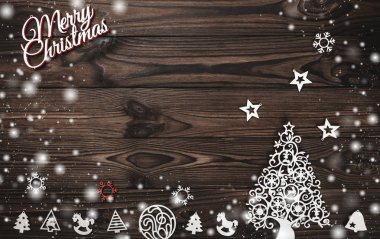 Yukarıdan bir Merry Christmas yazıt ve el yapımı Ağaç oyuncaklar ahşap arka plan, metin yazma, kar efekti için yer ile tebrik kartı üzerinde göster