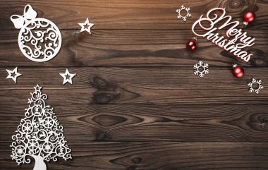 Yukarıdan görünümünü bir Merry Christmas yazıt ve el yapımı ağaç oyuncak ahşap arka plan üzerinde tebrik kartı, ampuller ile yazma metin için yer ile