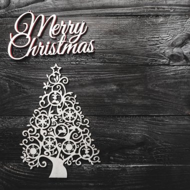 El yapımı yaprak dökmeyen Ağaç oyuncak görünümünü altın çam ve siyah ahşap arka plan, metin yazma, yeri olan kitabe neşeli Noel tebrik kartı