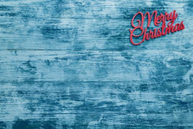 Neşeli Noel kartı, üstten görünüm, mavi ahşap arka plan. Xmas kutlama metin için yer