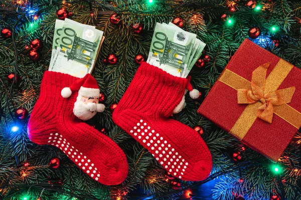 Background Fir Branches Santa Red Stockings Money Gift Christmas Card — Stock Photo, Image