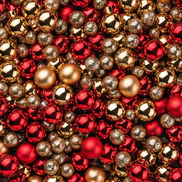 Christmas card. Wallpaper of red and gold baubles. Top view. Xmas square card.