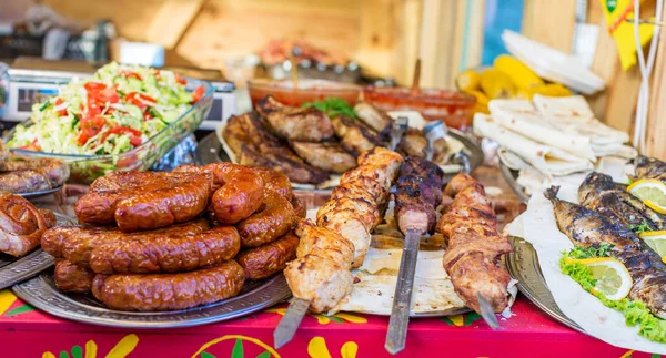 Sosis, şiş kebap, kızarmış balık, salata ve diğer gıda sokak gıda Festivali