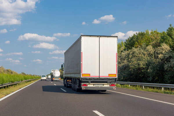 White truck on highway road on sunny day. Industrial transportation concept, export, import, logistic