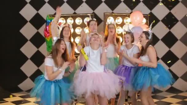 Grupa panny młodej przyjaciółki w kostiumach jednorożca, kolorowe spódnice powietrzne tańczące rzucając złote konfetti na hipsterską imprezę. — Wideo stockowe