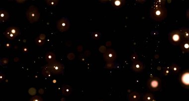 Siyah arkaplandaki soyut turuncu ve sarı parlak ışık parçacıkları