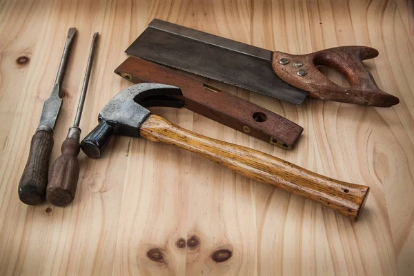 Old vintage wood tool on wooden background, saw hammer, screwdrive handle handcraft.