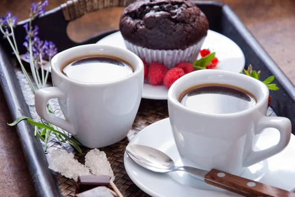 Black coffee in white cups and chocolate muffin for breakfast — Stock Photo, Image