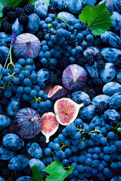 Fresh Blue fruit and berries, figs, grapes, prunes and dewberry Stock Picture