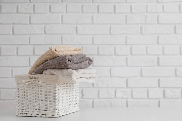 Multicolor Fresh Towels Wicker Straw Basket White Table White Brick — Stock Photo, Image