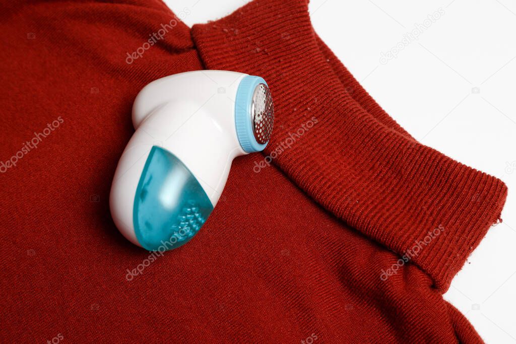 Device for removing lint from wool clothes. Golf with fuzz ball isolated on white background.
